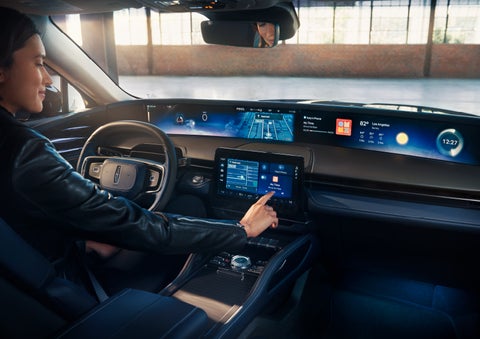 The driver of a 2024 Lincoln Nautilus® SUV interacts with the center touchscreen. | Parkway Lincoln in Dover OH